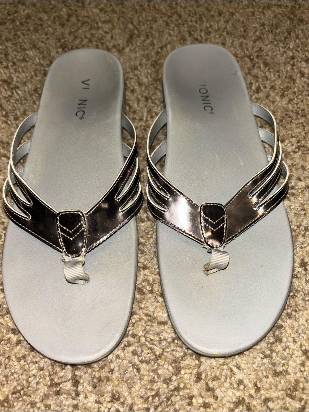 Vionic Alta silver leather flip-flops featuring metallic crisscross straps